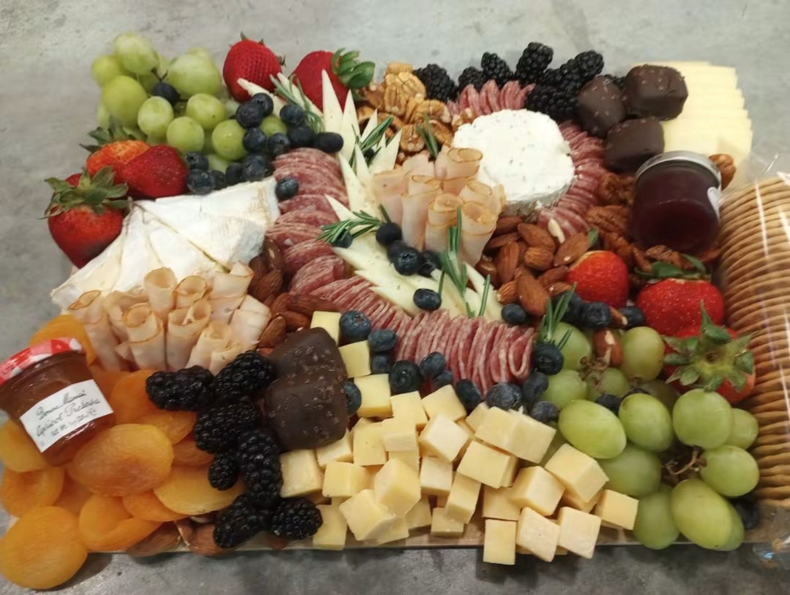 Abundant charcuterie board with fruit cheese and nuts