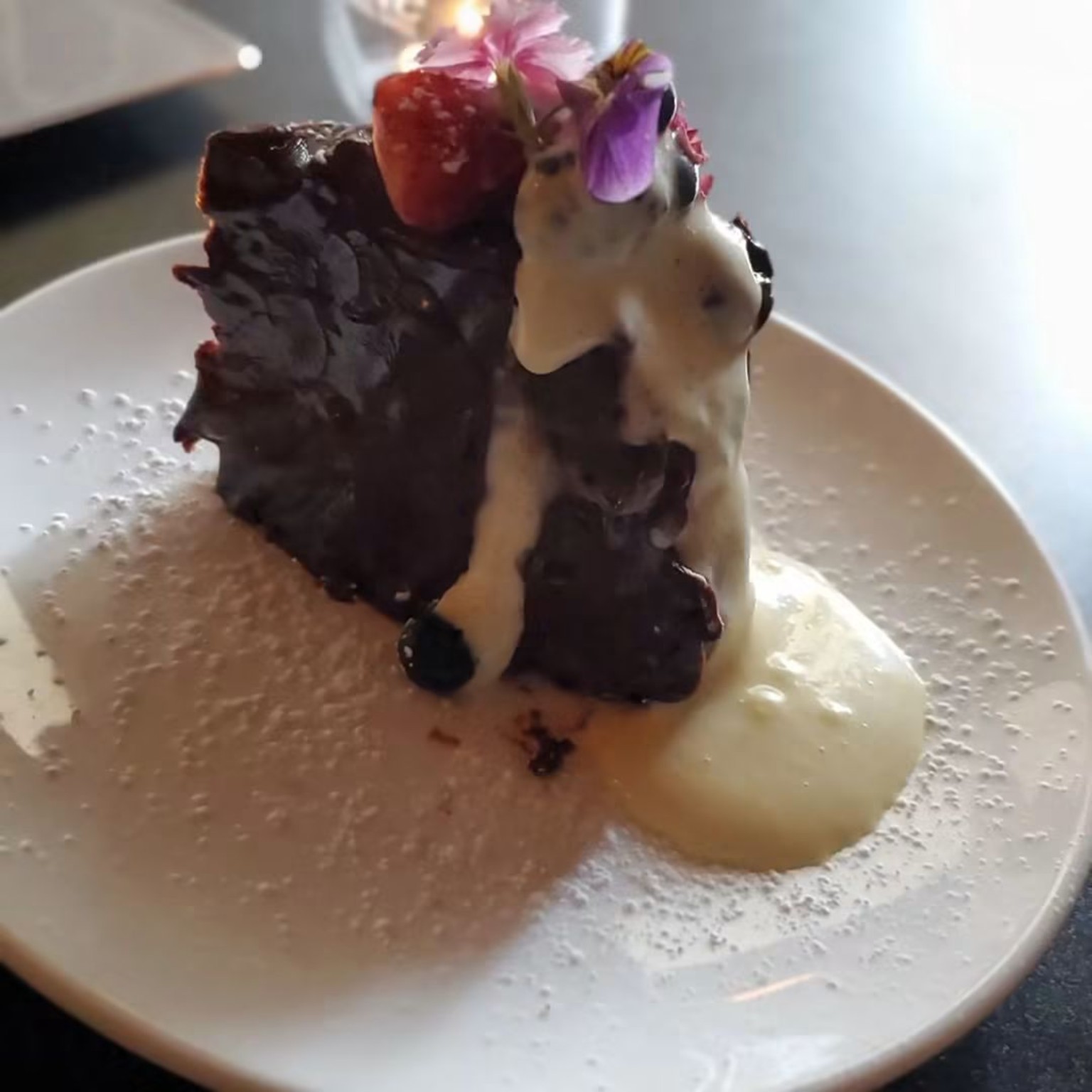 Chocolate dessert with berries and cream
