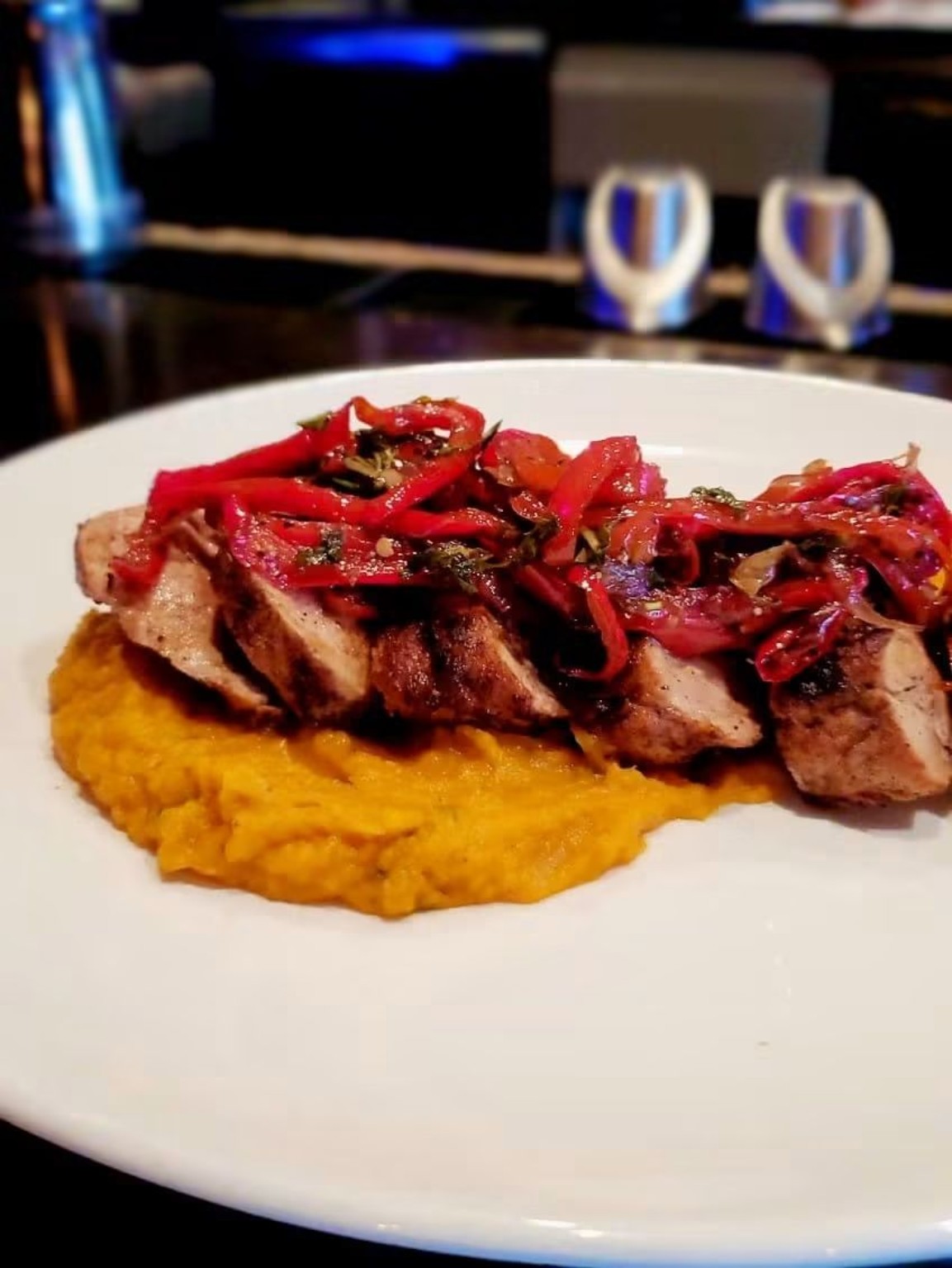 Plated entrée with roasted vegetables and puree