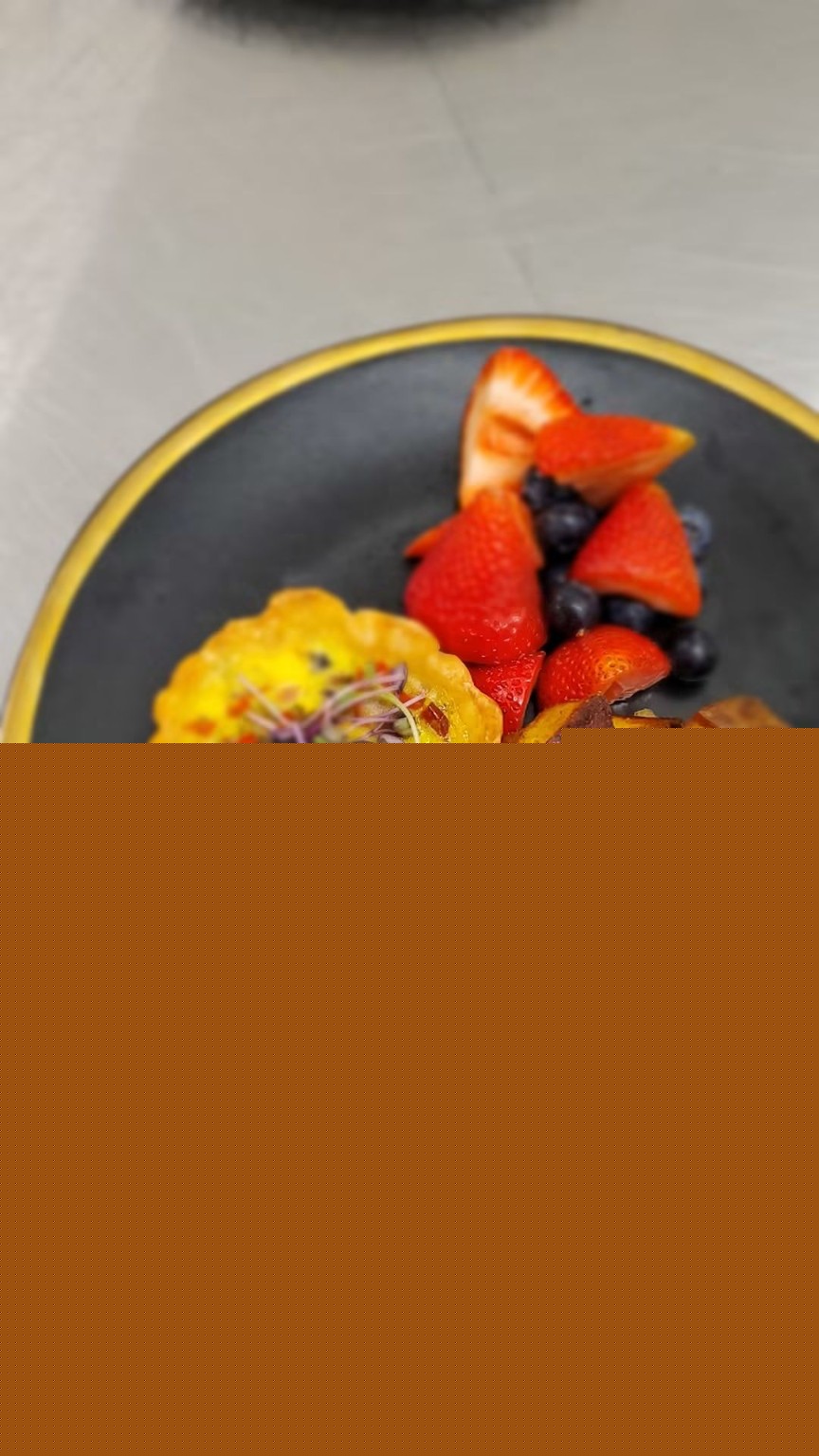 Quiche-style brunch plate with fruit and roasted potatoes