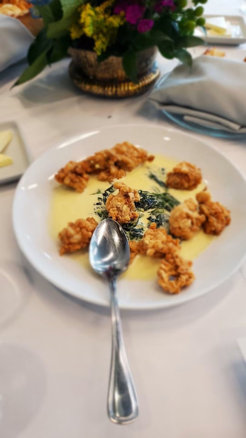 Crispy bite-sized dish with greens and sauce