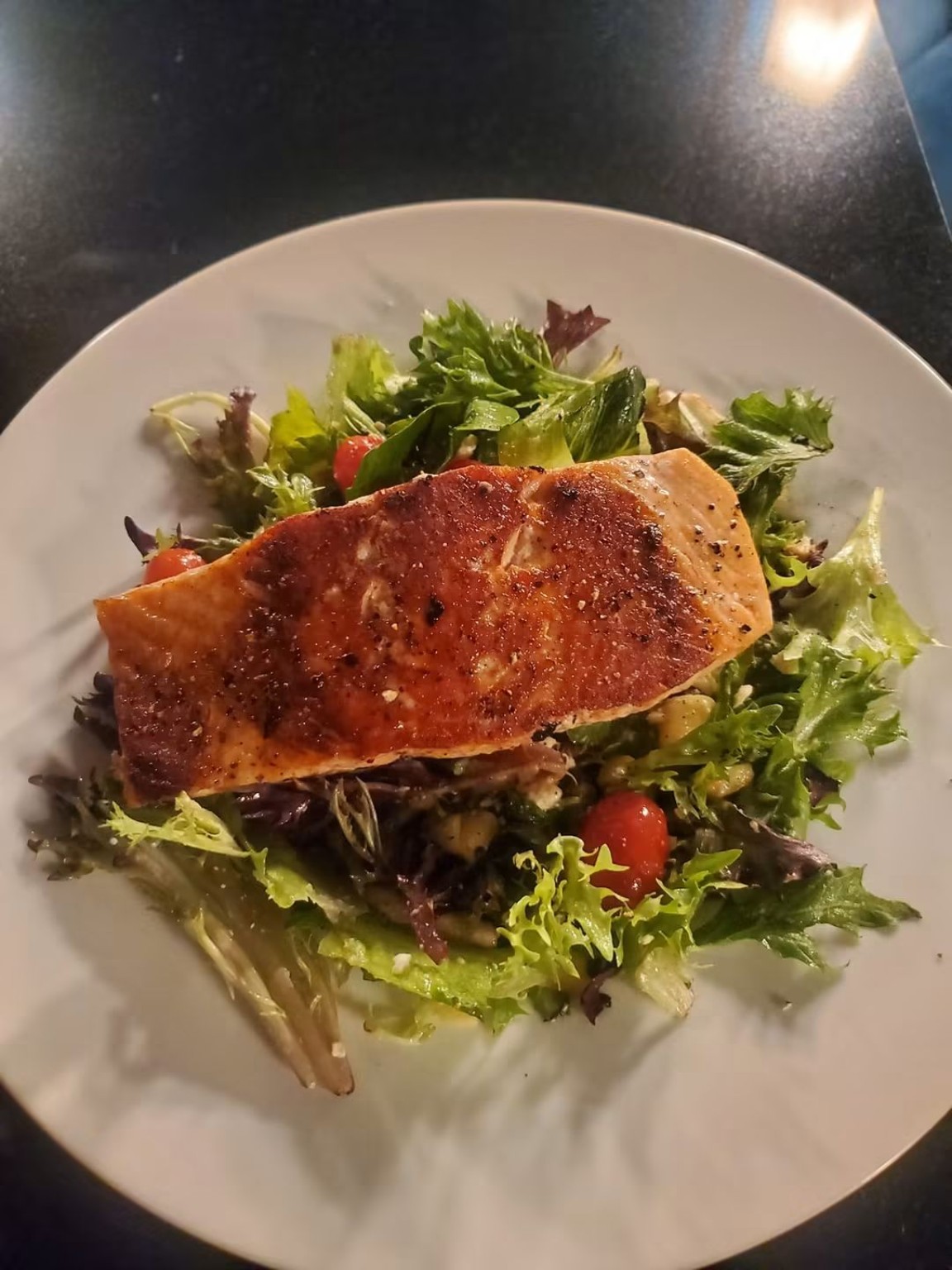 Roasted salmon over a fresh mixed salad
