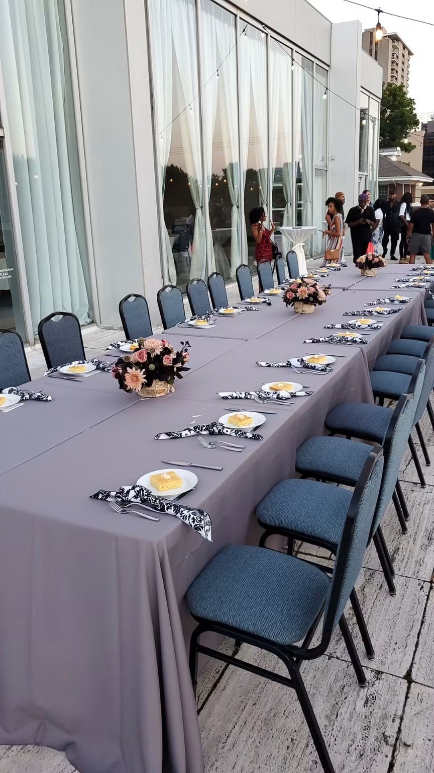 Long table with blue napkins and place settings