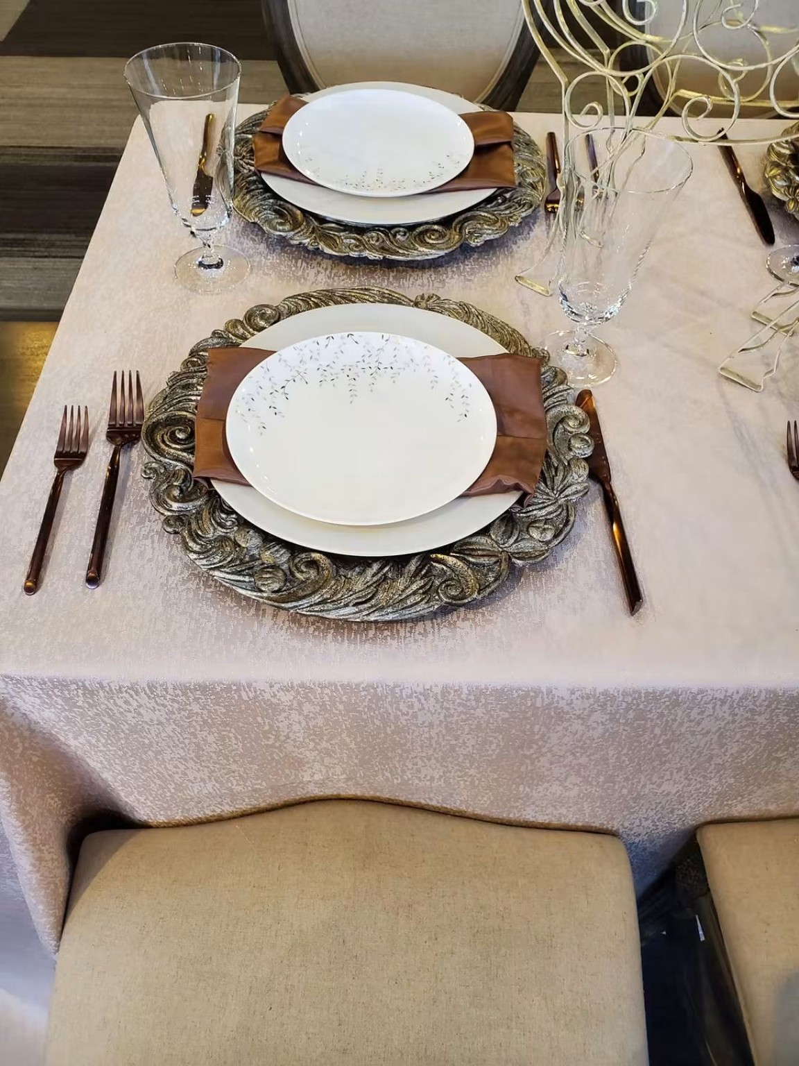 White and gold place setting with a folded napkin