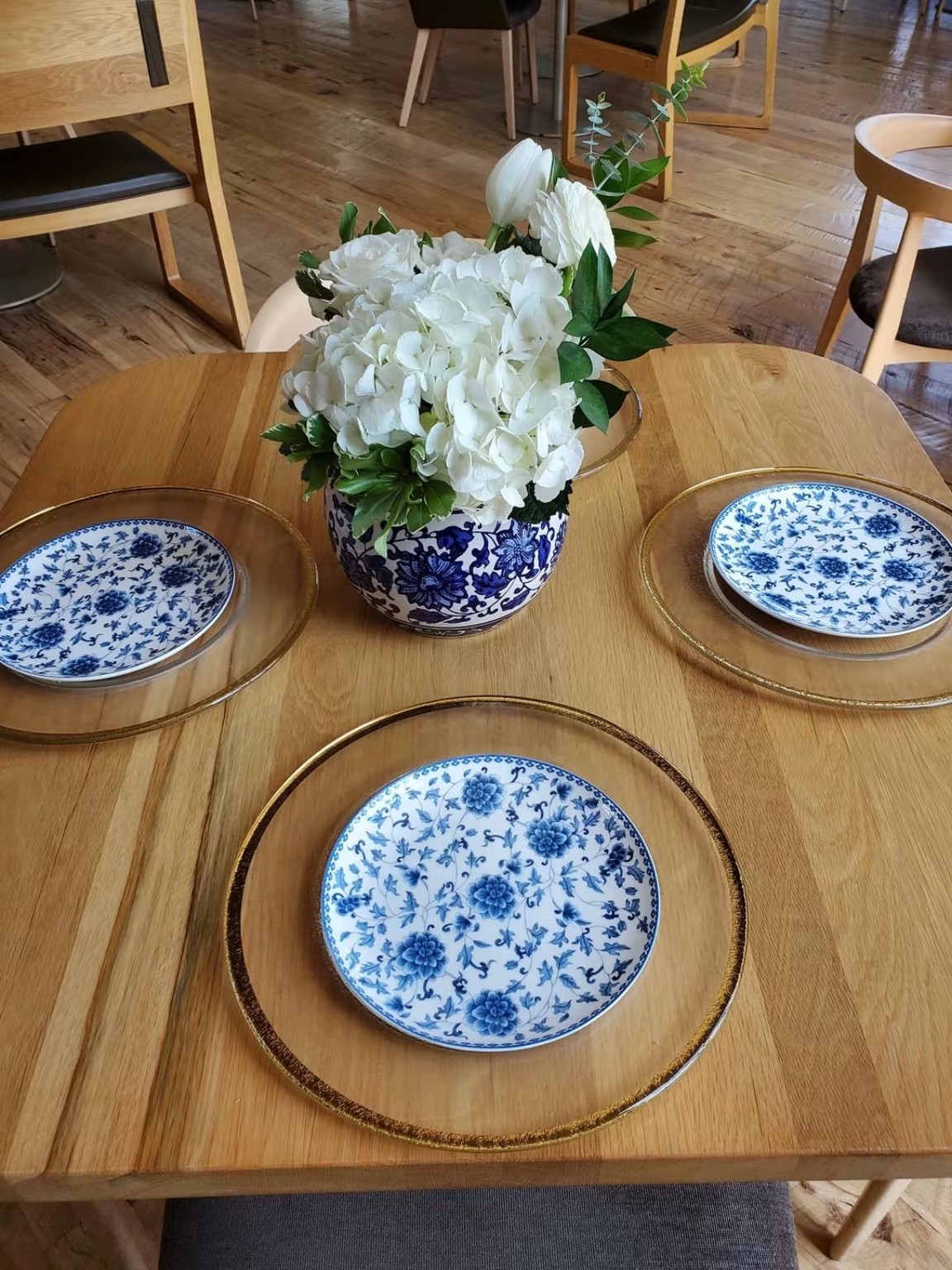 Blue and white place setting on a wood table