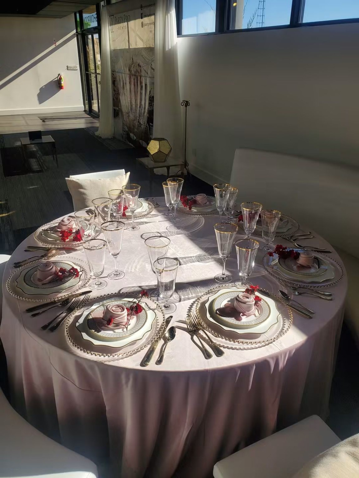 Round formal table with pink and white place settings