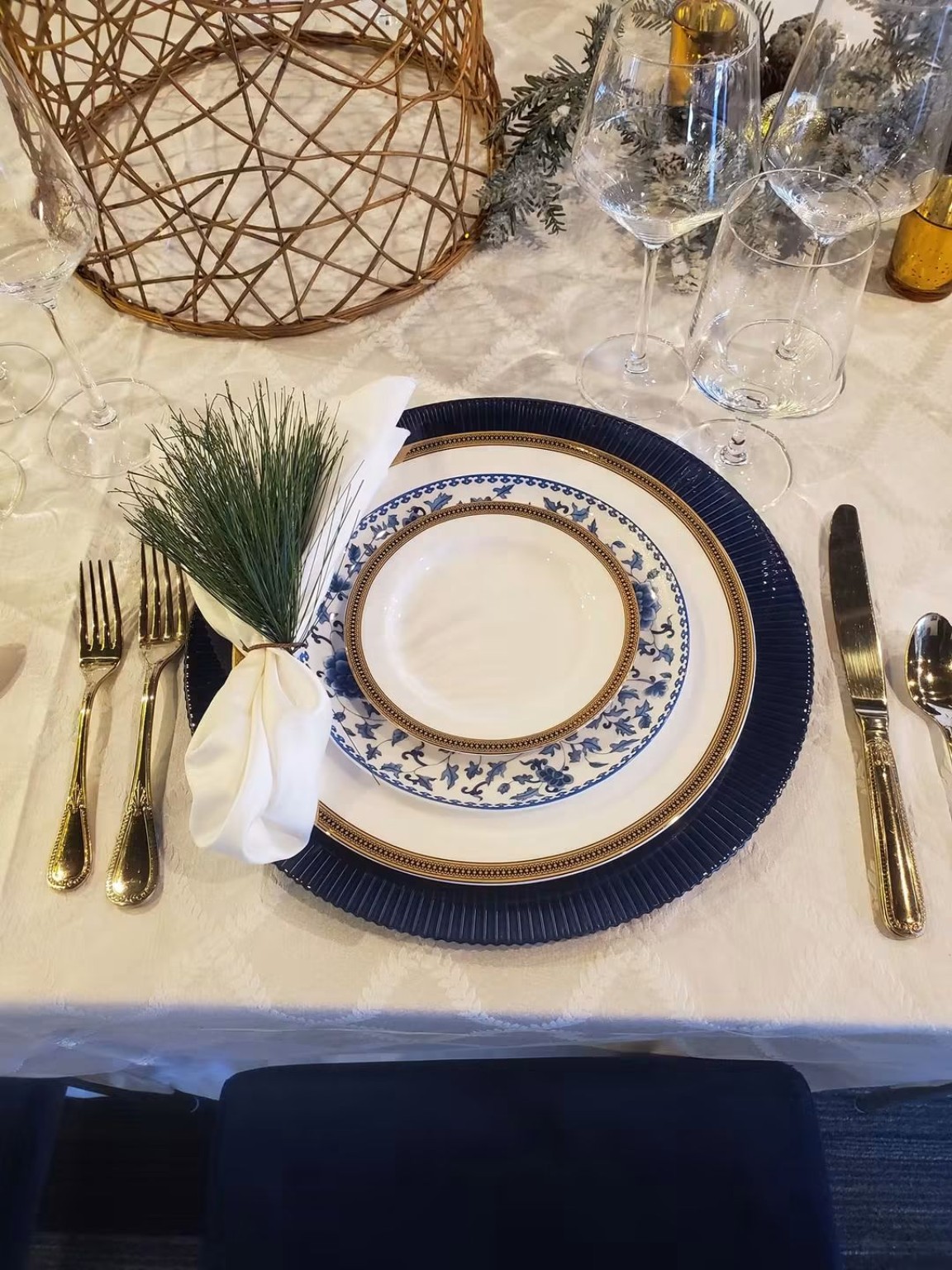 Blue and white place setting with greenery