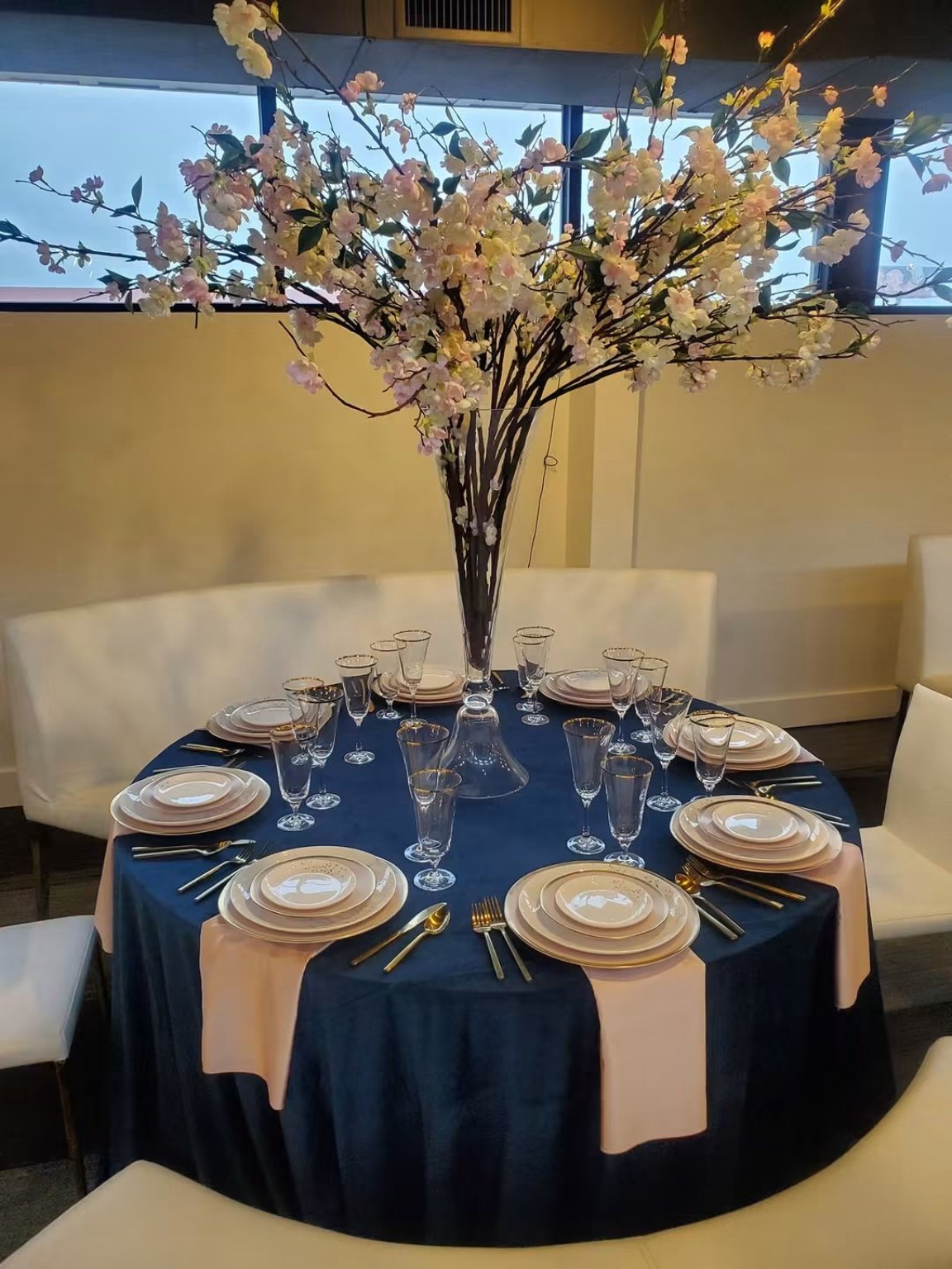Blue tablecloth dining table with floral centerpiece