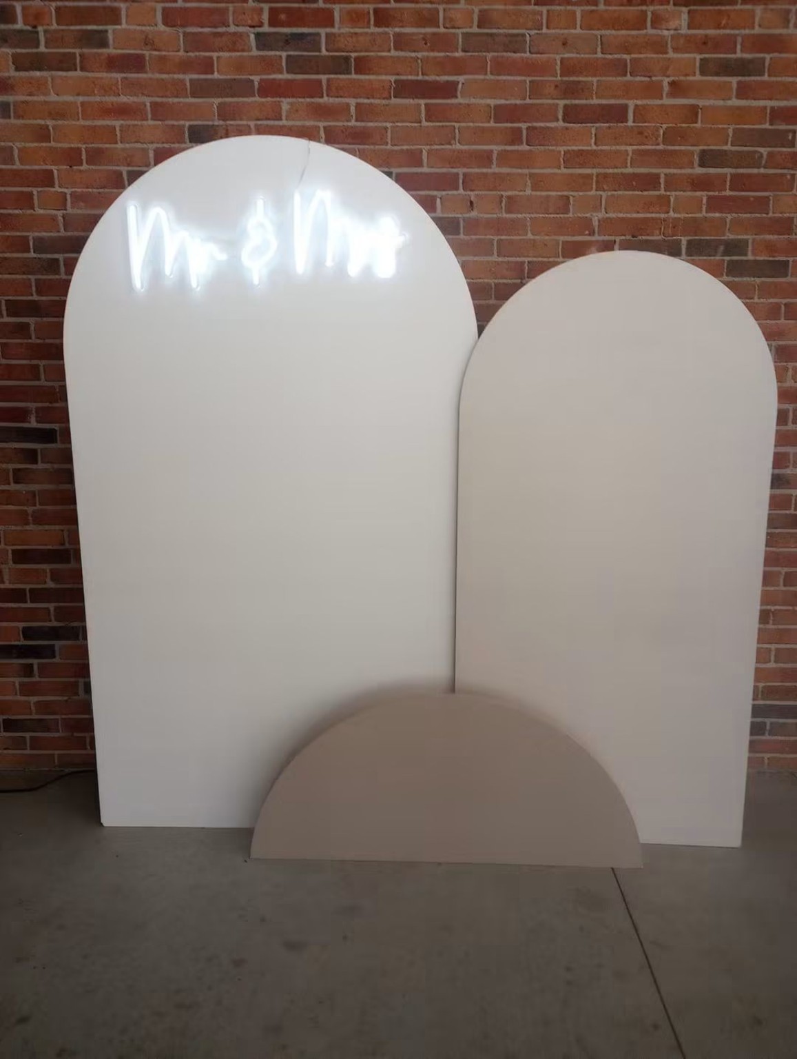 White ceremony chairs and event backdrop