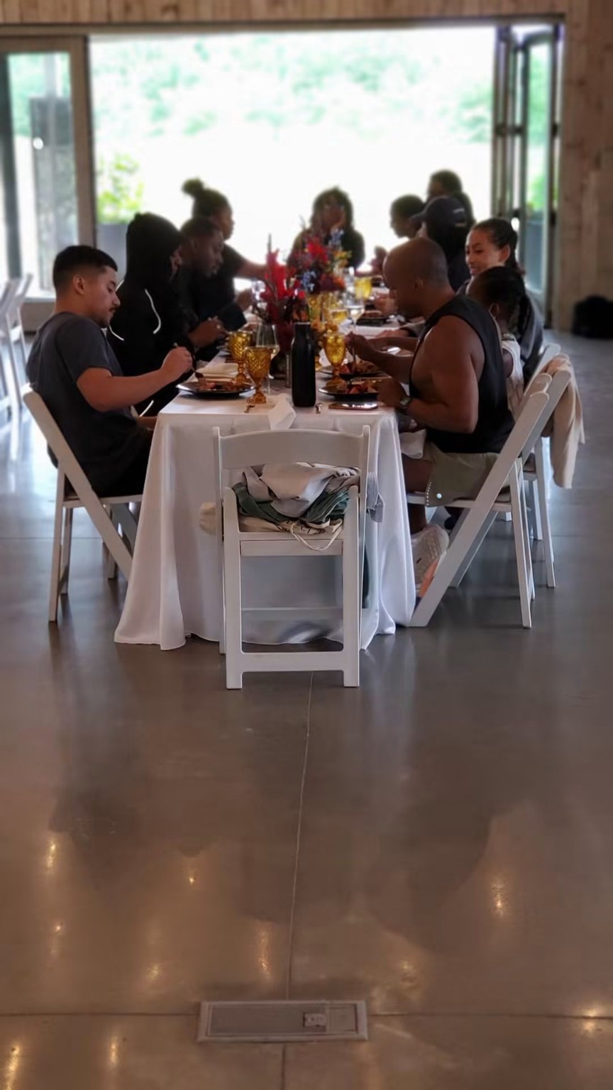 Guests gathered around a long catered dining table
