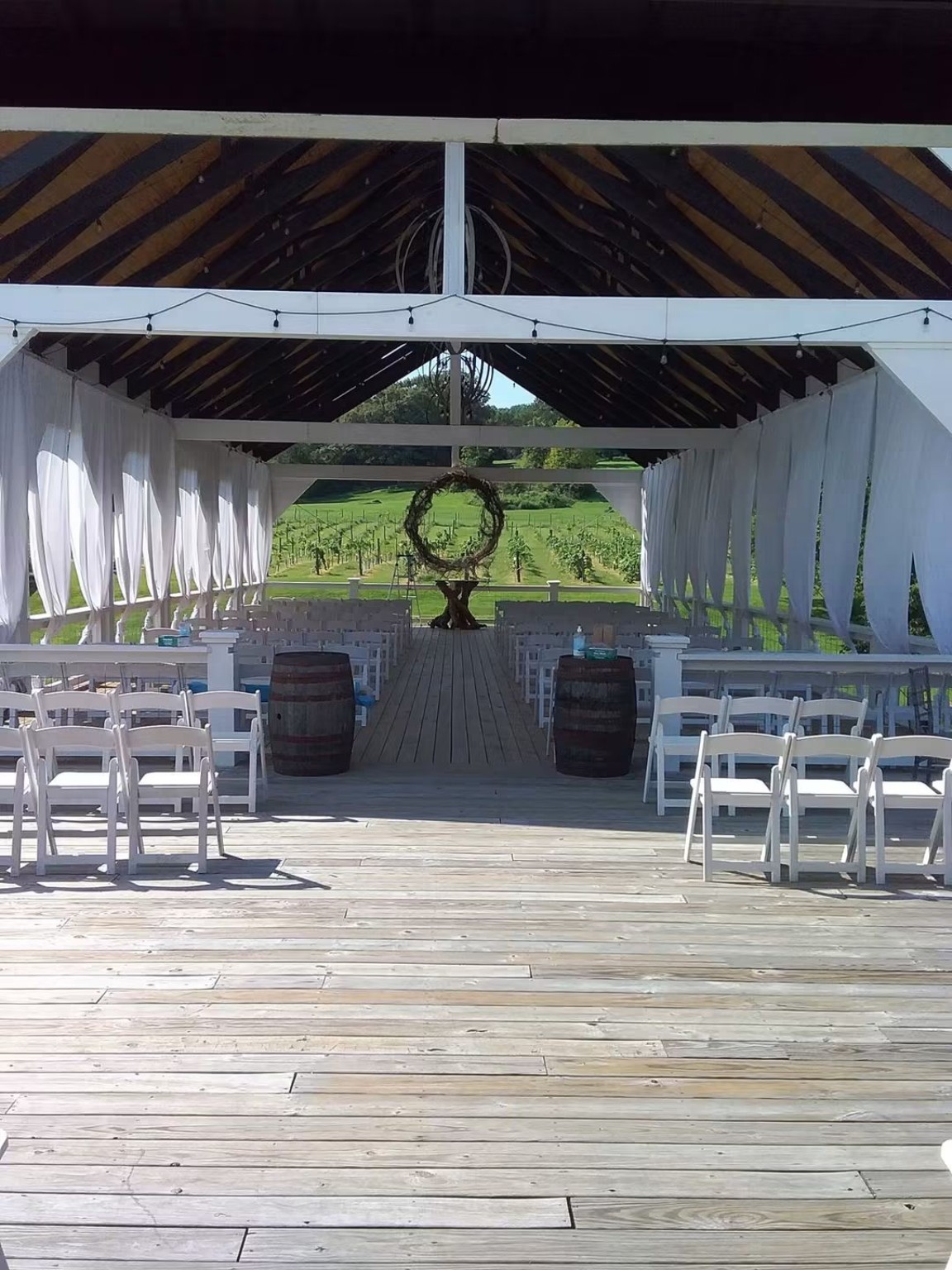Ceremony and reception setup under a decorated structure