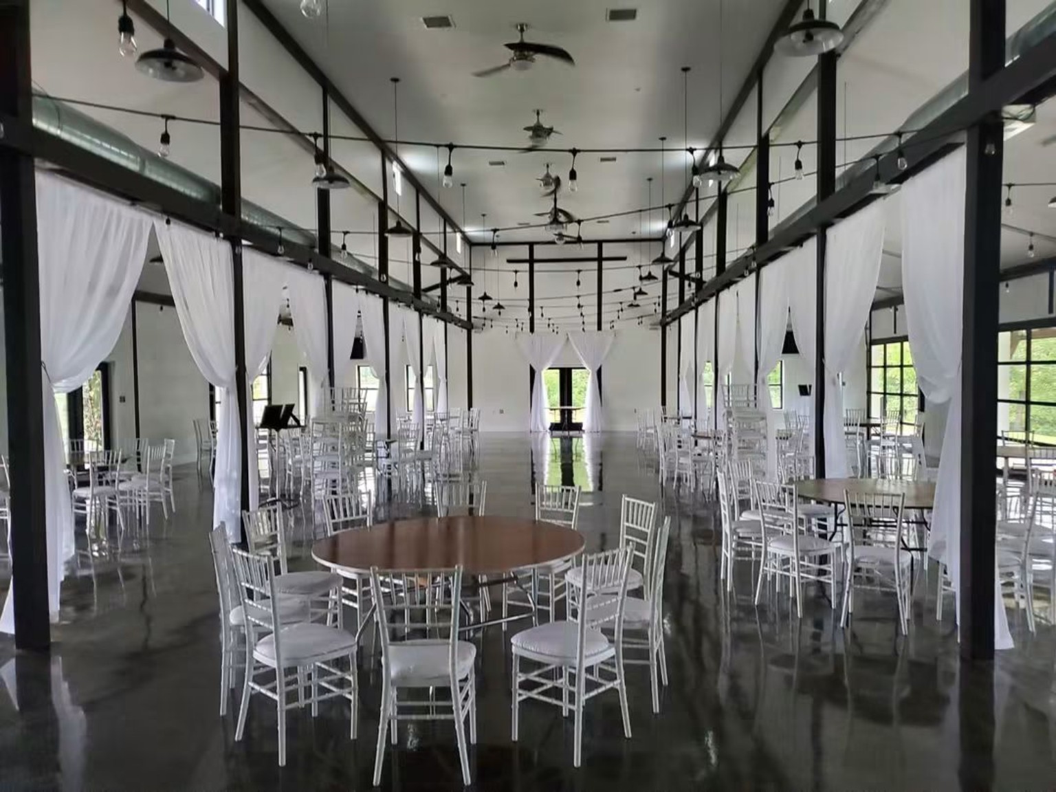 Elegant event venue with reflective columns and chandeliers